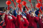 Children holding pBuzz trombones in the air